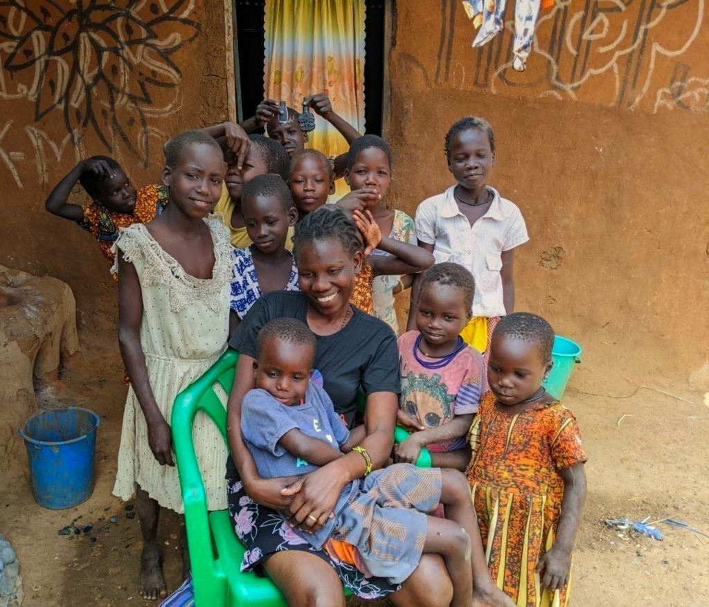Agnes Lotukei with children smiling