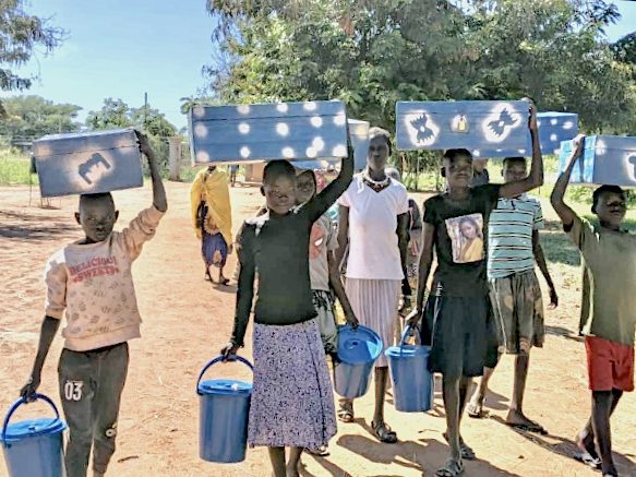 Students move into school carrying buckets and boxes for their belongings